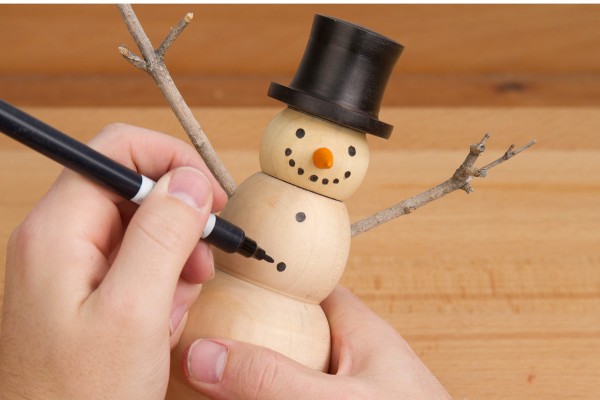 Adding buttons to the snowman with a black marker.