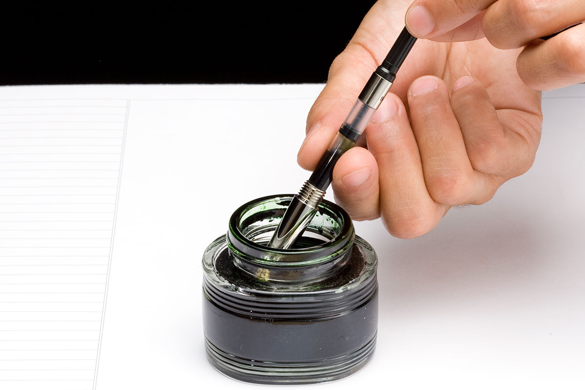 Filling a fountain pen cartridge from an ink bottle.