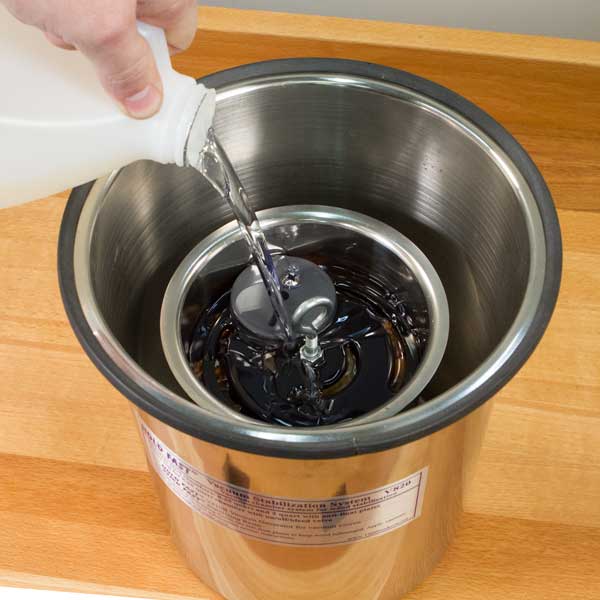 Pouring resin into a steel pot.