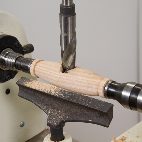 Drilling a hole perpendicular to the handle.