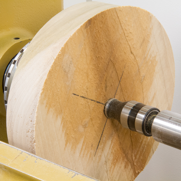 A blank mounted between centers on a lathe.
