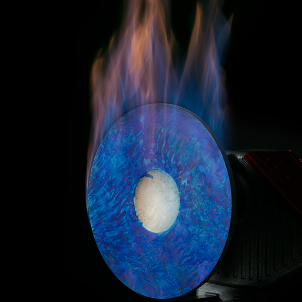 A blue dyed platter with flames from the burning alcohol.