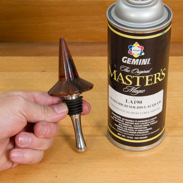 A can of spray lacquer and a bottle stopper.