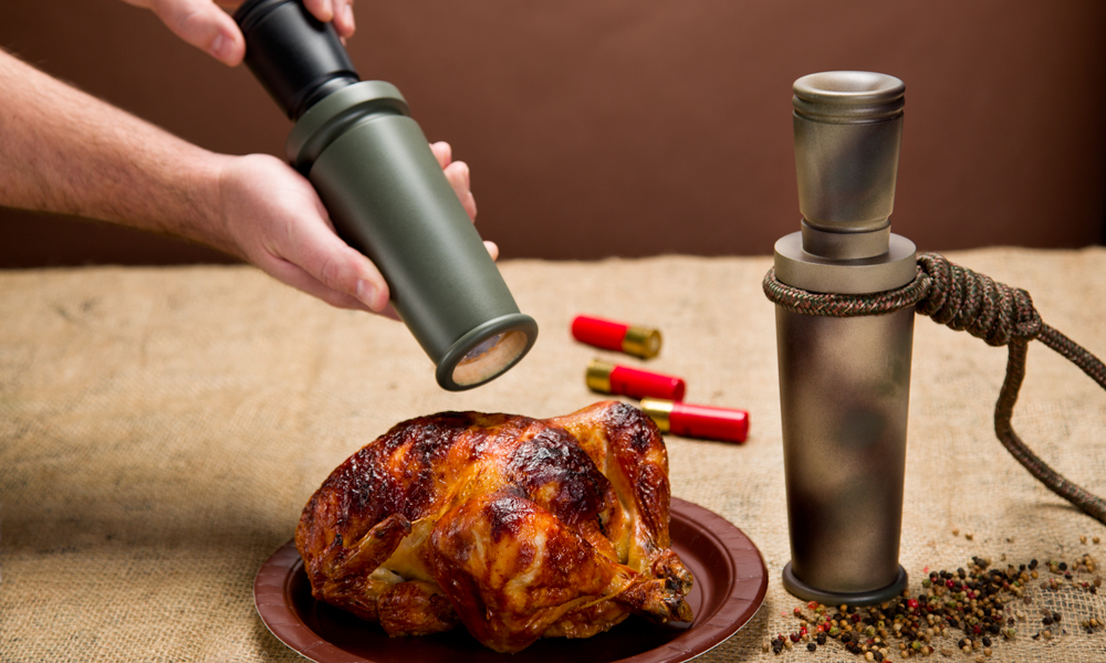 Cracking pepper on a roasted chicken with a duck call style pepper mill.