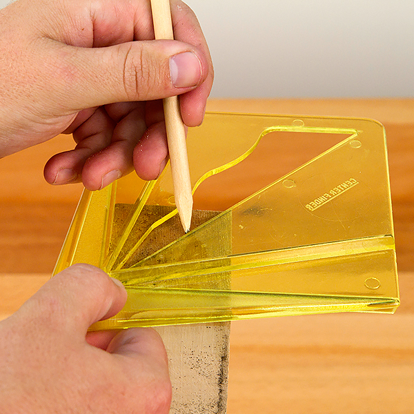 Using a template to mark the center of a wood blank.