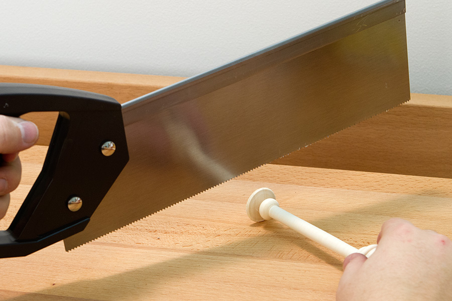 Cutting of the waste end with a handsaw.
