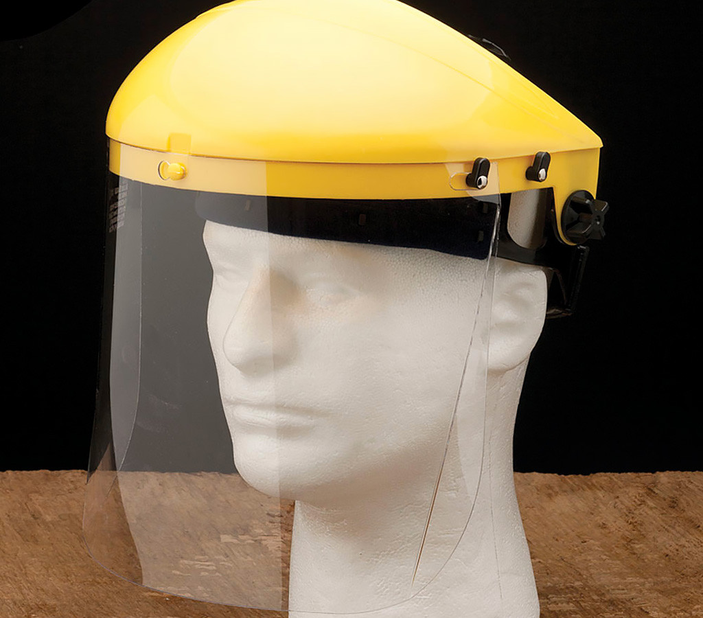 A face shield displayed on a foam head.
