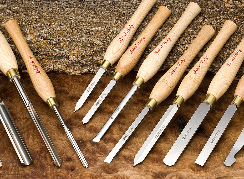 A group of Robert Sorby tools laid on a wood background.