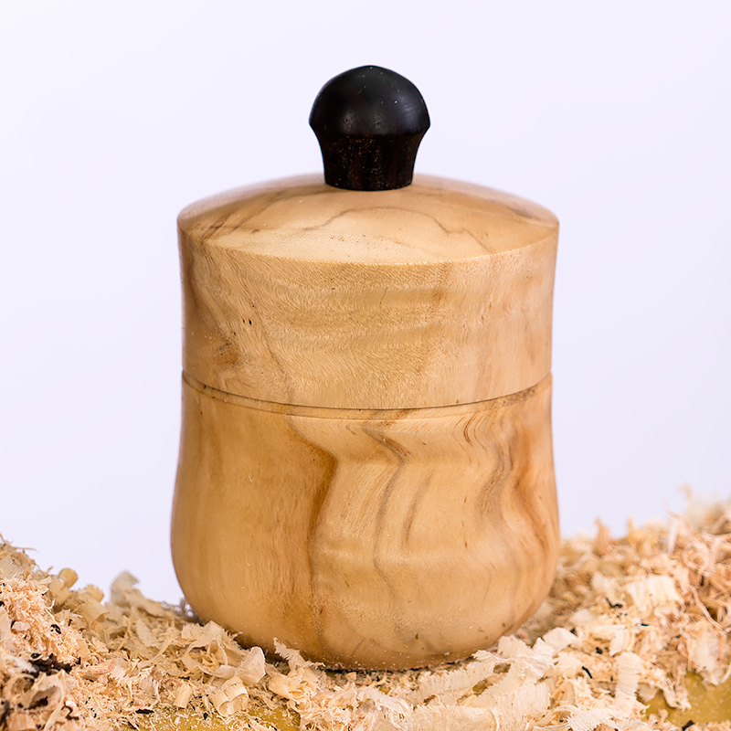 The completed salt canister sitting in a pile of wood shavings.