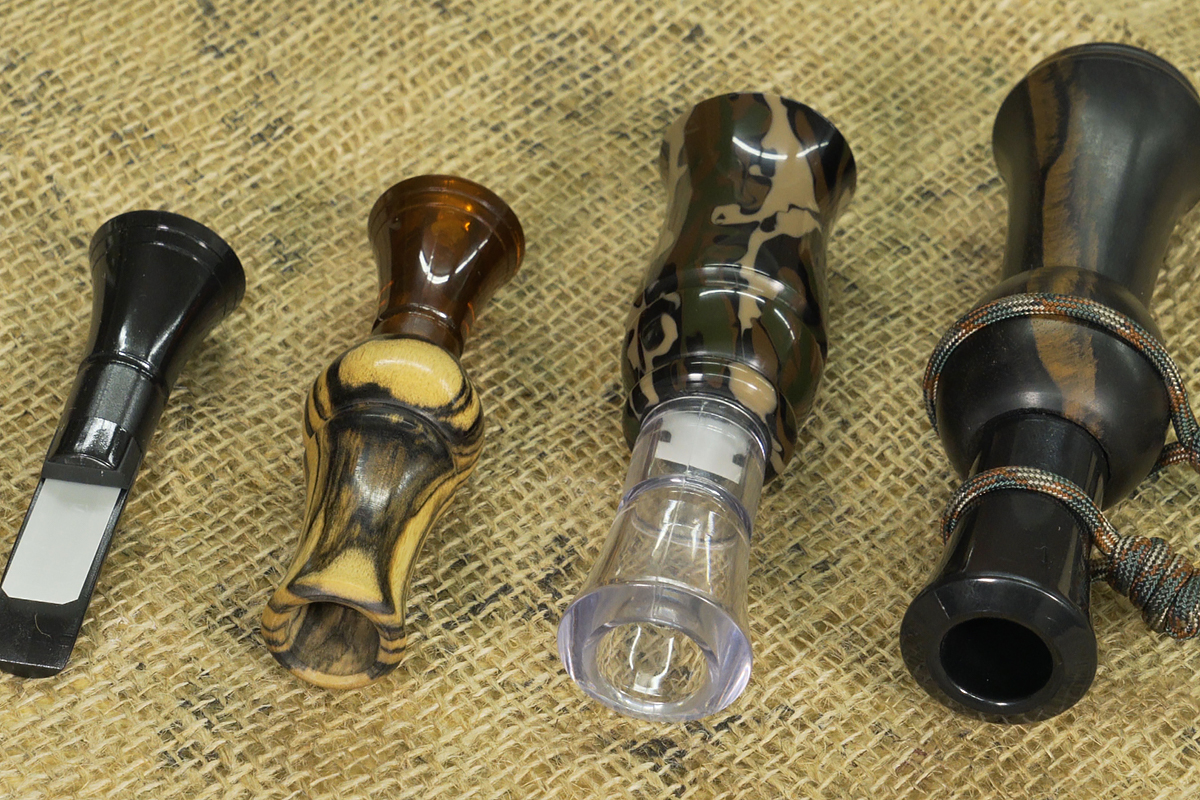 A selection of game calls laying on burlap.