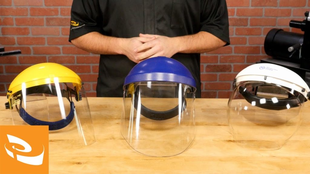 A selection of three face shields on a table.