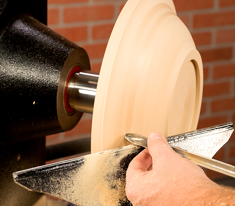 Turing the exterior of the platter with a bowl gouge.