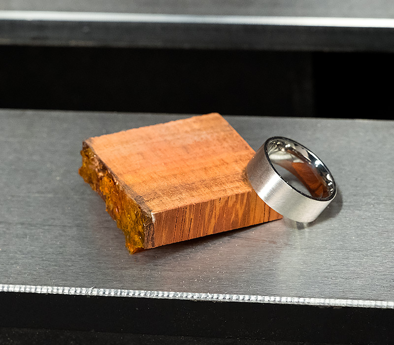 A ring core and blank laying on a lathe bed.