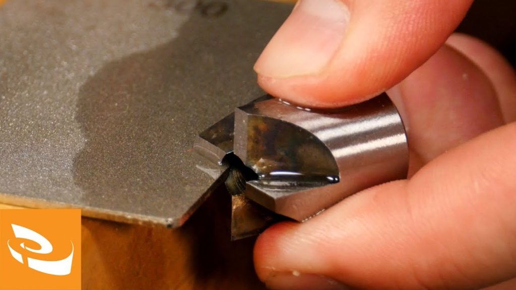 Sharping a barrel trimmer on a diamond stone.