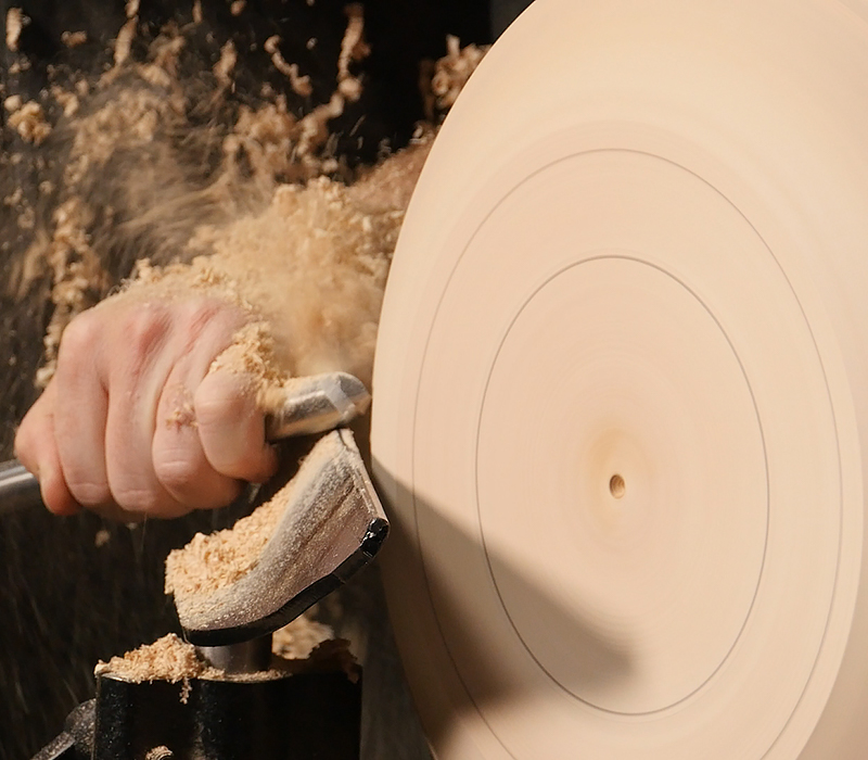 Turing the exterior bowl shape with a bowl gouge.