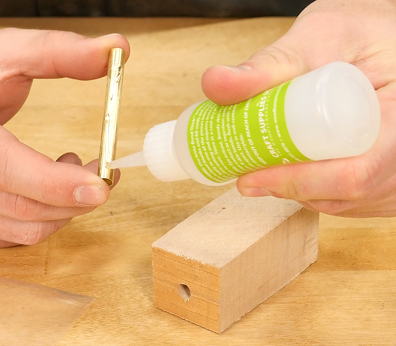 Applying CA glue to a brass tube.