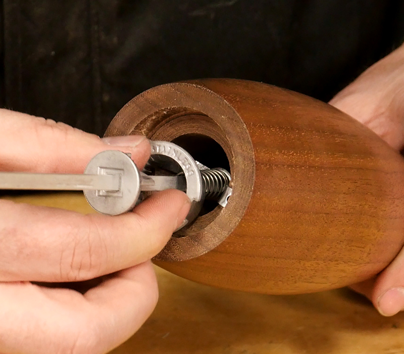 Inserting the mill components into the body.