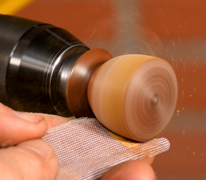 Sanding the blank with the lathe running.