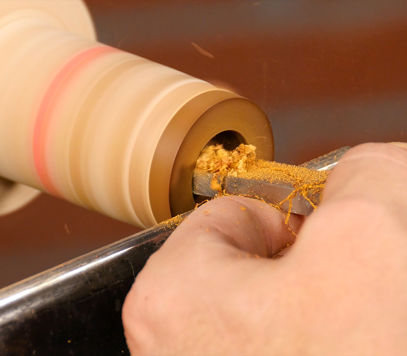 Enlarging the hole with a ring scraper tool.