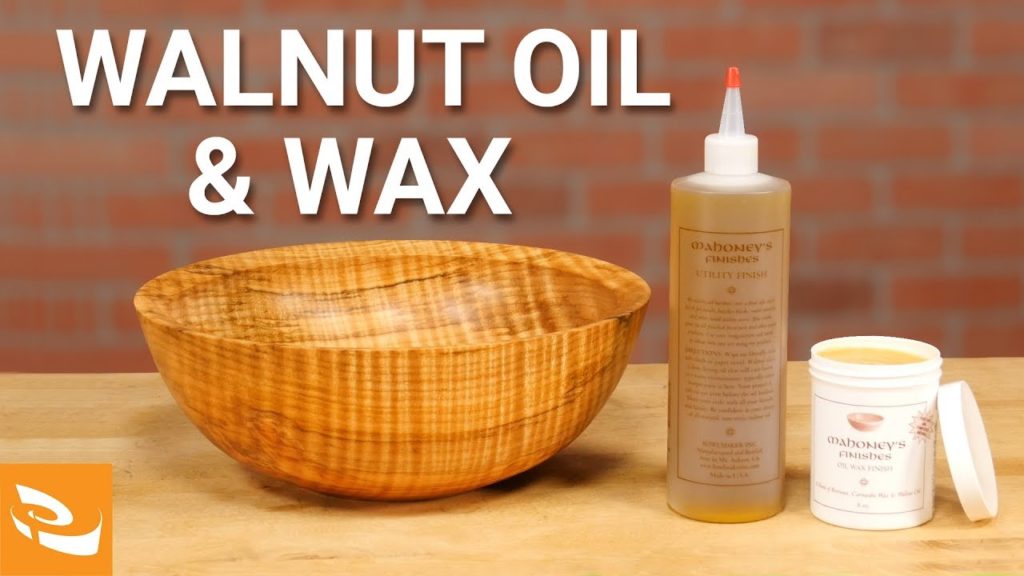 A turned bowl, walnut oil, and walnut wax on a table.