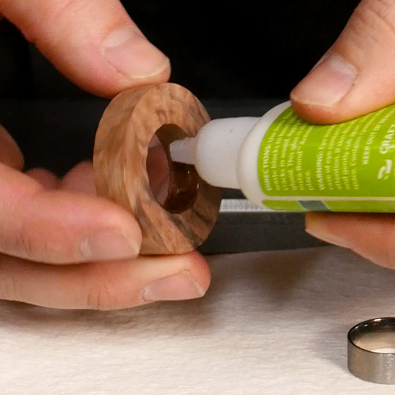 Applying glue to the inside of the ring blank.