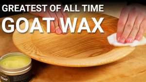 Applying wax to a turned platter.